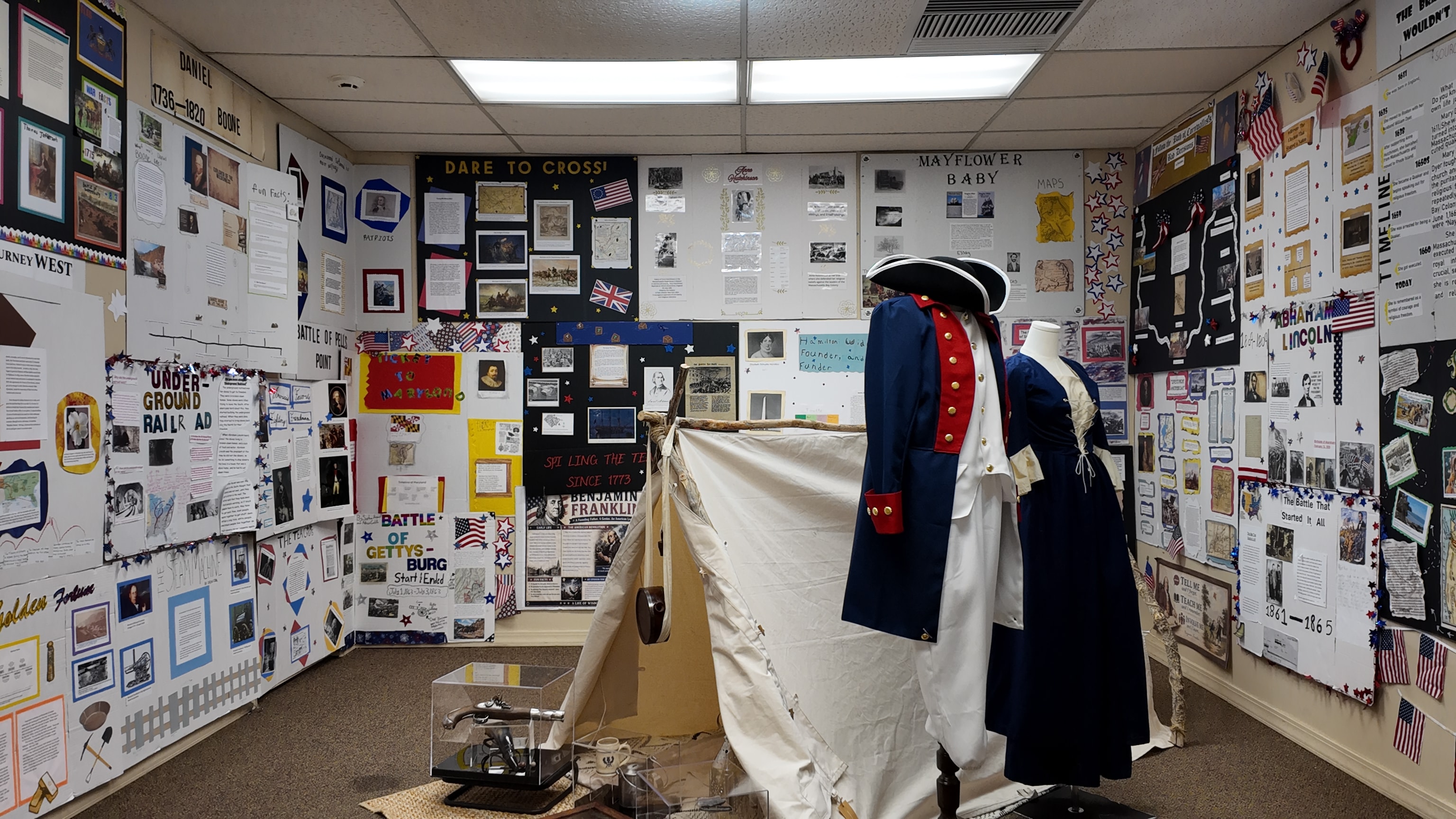 Museum exhibit with patriotic display and historical artifacts
