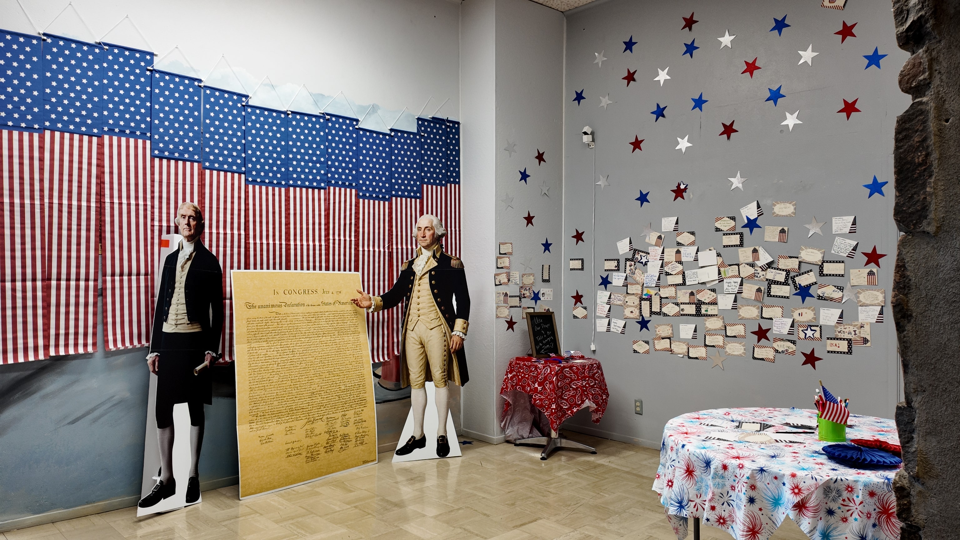 American flag backdrop with founding fathers exhibit