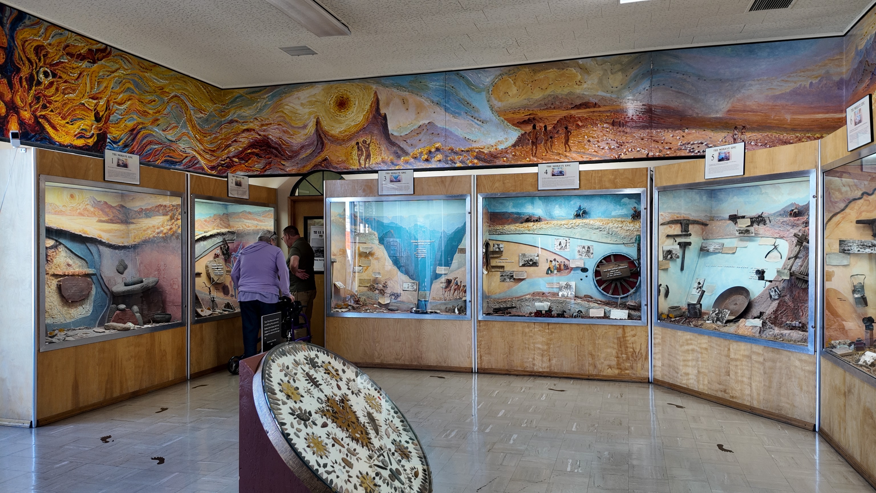 Museum gallery with diorama displays and artwork