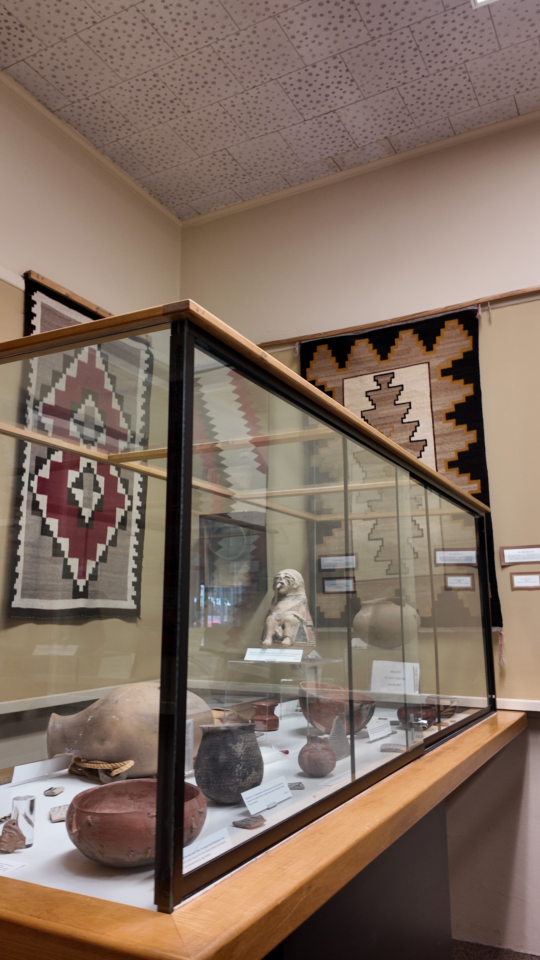 Native American textiles and pottery display cases