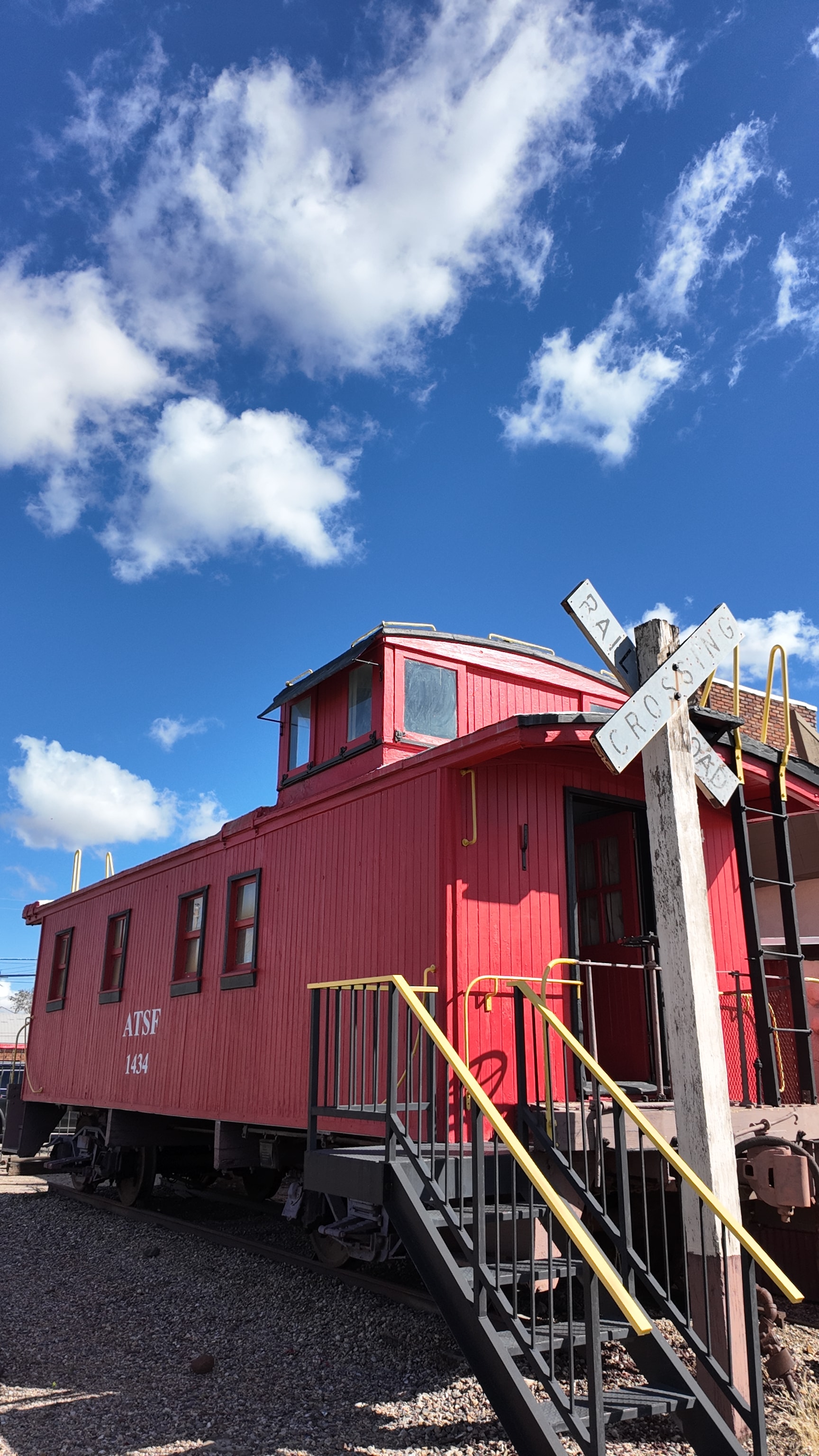 ATSF red railroad caboose with crossing sign
